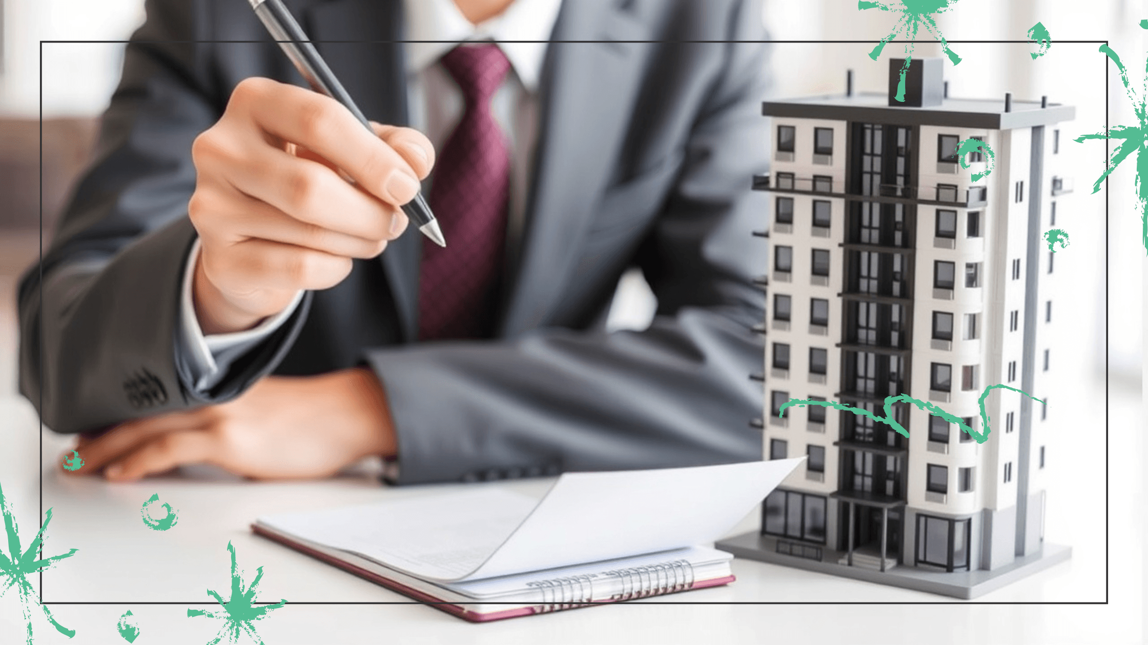 A person in a suit writes notes on a notepad beside a condo model.